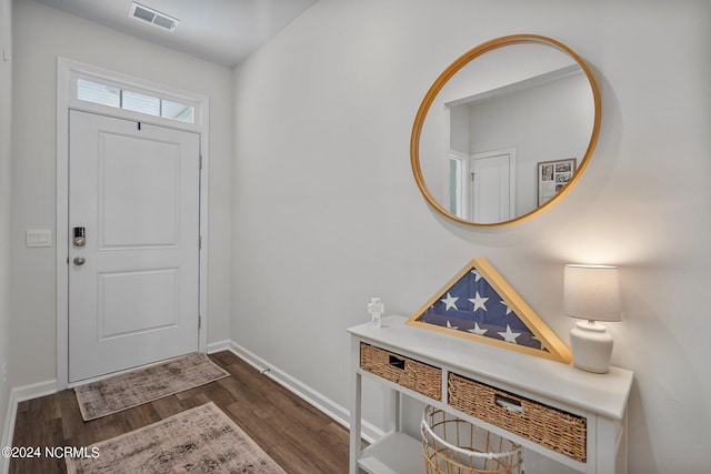 entryway featuring dark wood finished floors, visible vents, and baseboards