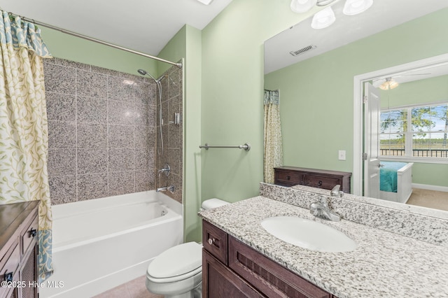 bathroom featuring toilet, shower / tub combo, vanity, and visible vents