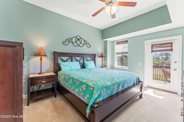 bedroom with access to exterior, multiple windows, a ceiling fan, and carpet flooring