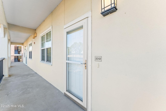 property entrance featuring stucco siding