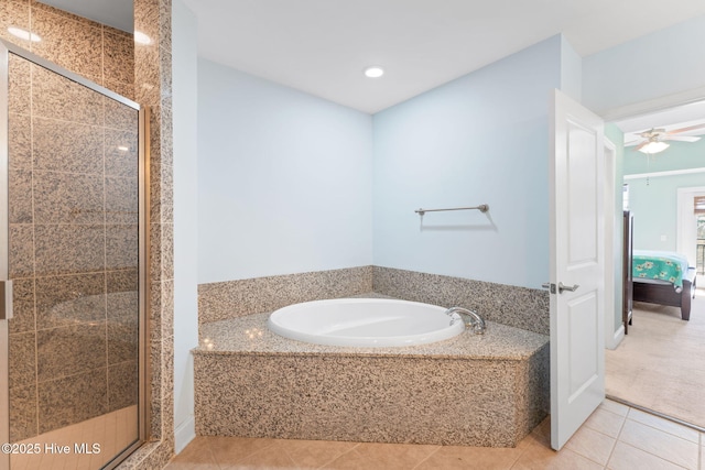 ensuite bathroom with ceiling fan, connected bathroom, a bath, tile patterned floors, and a stall shower