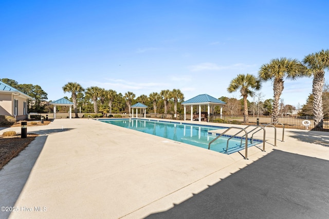 community pool featuring a patio area, fence, and a gazebo