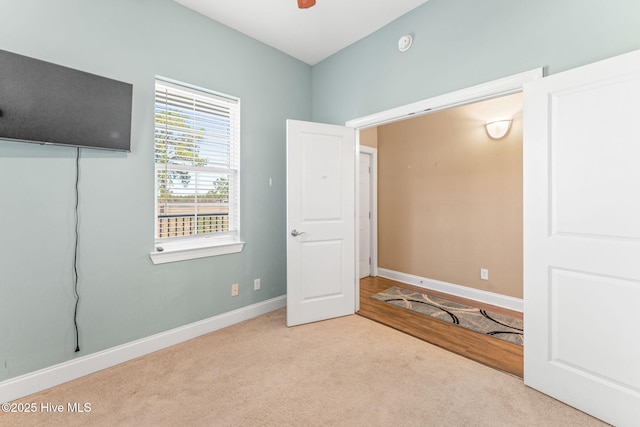 unfurnished bedroom with carpet floors and baseboards