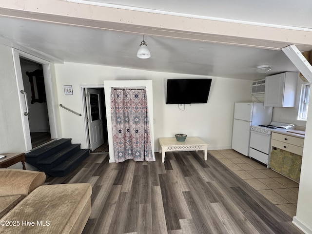 living room with stairs, dark wood-style flooring, vaulted ceiling, and baseboards