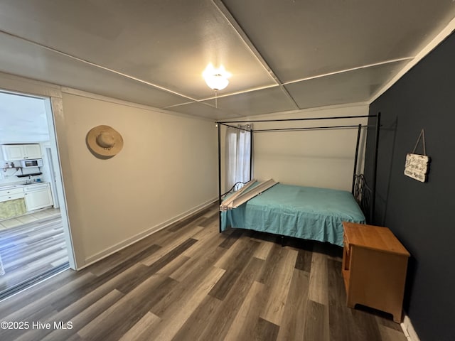 bedroom with wood finished floors and baseboards