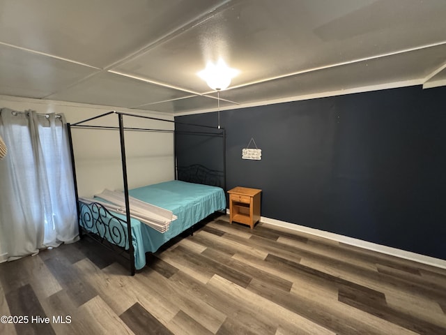 bedroom featuring wood finished floors and baseboards