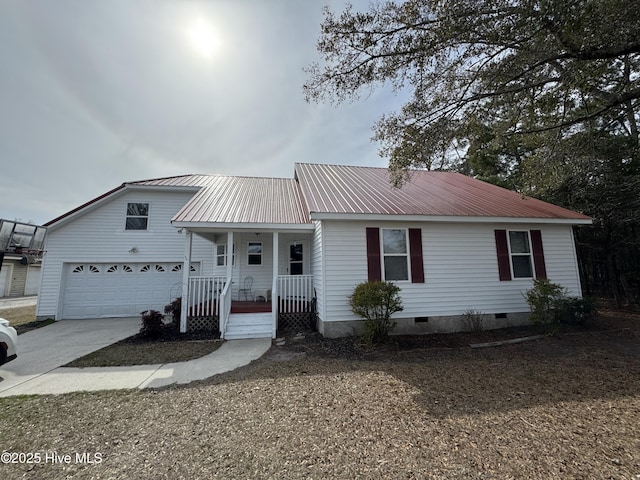 ranch-style house with covered porch, crawl space, metal roof, a garage, and driveway