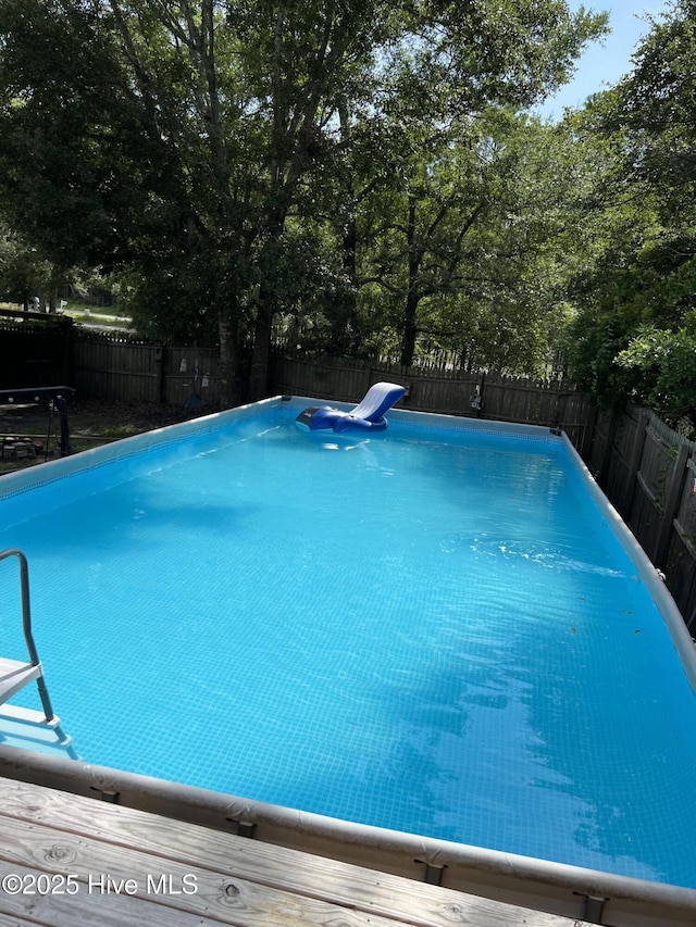 view of swimming pool with a fenced in pool and a fenced backyard