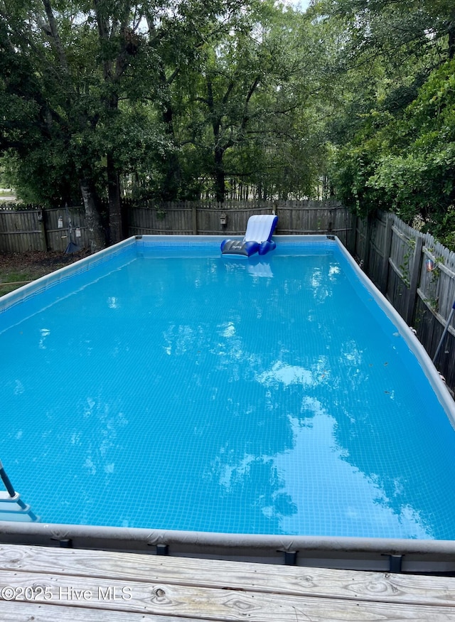 view of pool featuring a fenced backyard and a fenced in pool