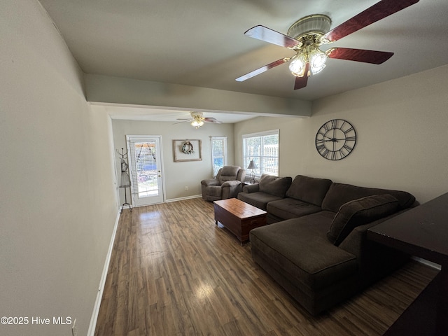 living area featuring ceiling fan, baseboards, and wood finished floors