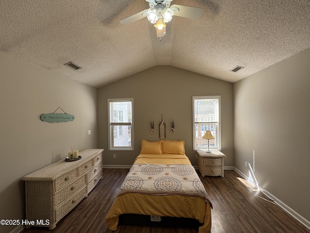 bedroom with vaulted ceiling, visible vents, dark wood finished floors, and ceiling fan