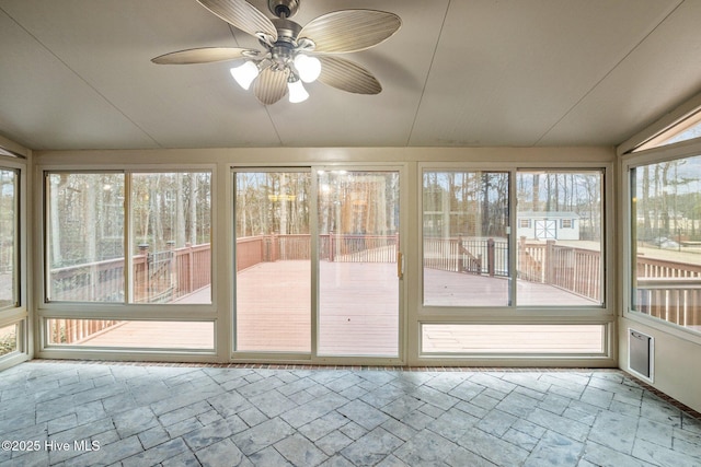 unfurnished sunroom featuring ceiling fan and vaulted ceiling