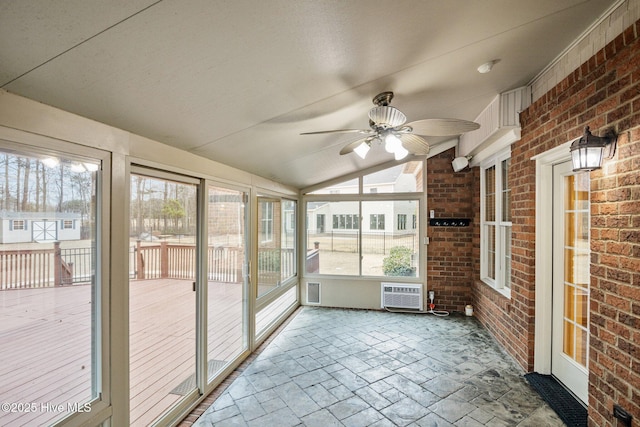 unfurnished sunroom featuring lofted ceiling and a ceiling fan