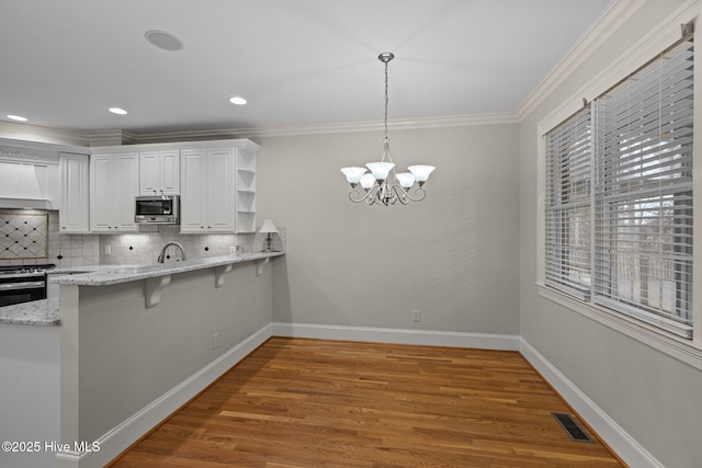 kitchen featuring open shelves, appliances with stainless steel finishes, ornamental molding, white cabinets, and baseboards