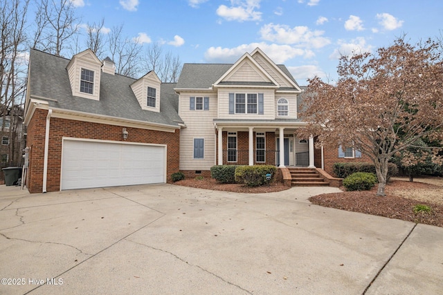 view of front of home with a garage, a porch, concrete driveway, and brick siding