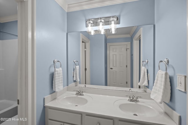 bathroom with ornamental molding, a sink, shower / bathtub combination, and double vanity