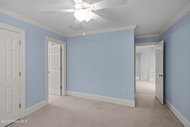 unfurnished bedroom featuring ornamental molding, carpet, and baseboards