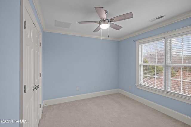 unfurnished bedroom featuring ornamental molding, light colored carpet, visible vents, and baseboards