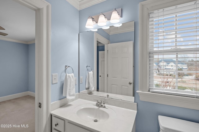 bathroom with ornamental molding, baseboards, vanity, and toilet