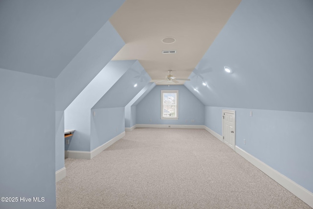 bonus room featuring lofted ceiling, carpet floors, visible vents, and baseboards