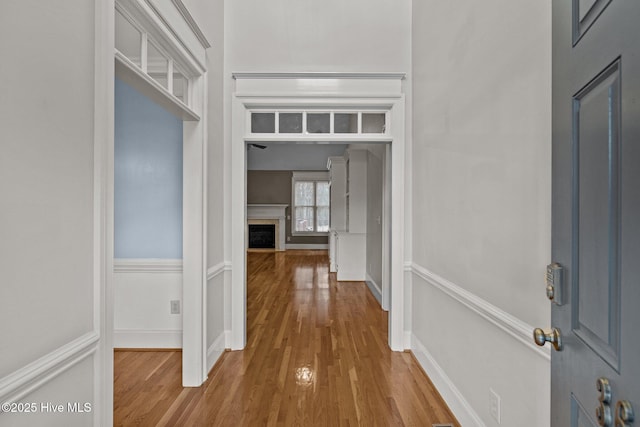 hallway with baseboards and wood finished floors