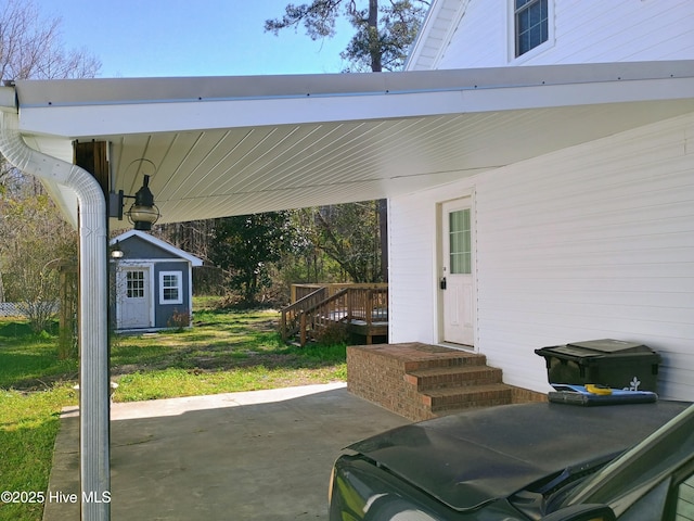 view of patio featuring an outdoor structure and a shed