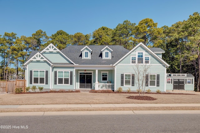 craftsman-style house featuring a porch and fence