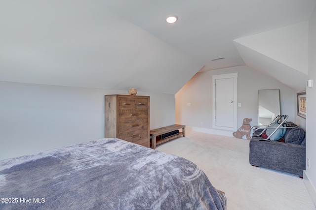 bedroom with lofted ceiling, carpet, and visible vents