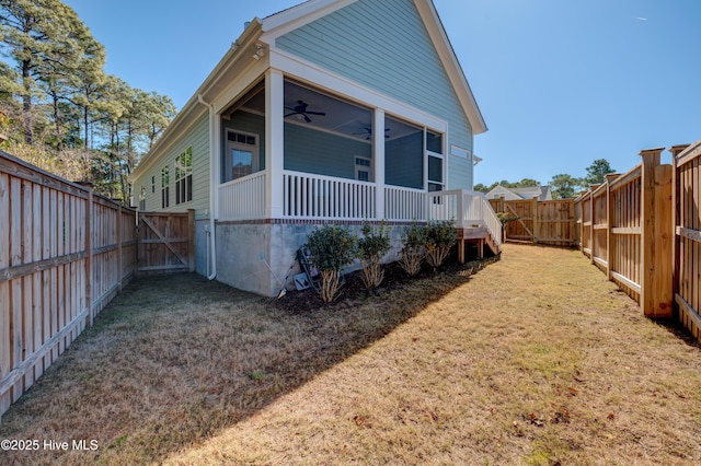 view of property exterior with a yard, a fenced backyard, and a ceiling fan