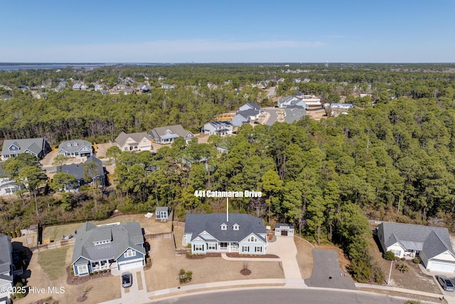 drone / aerial view with a residential view and a view of trees