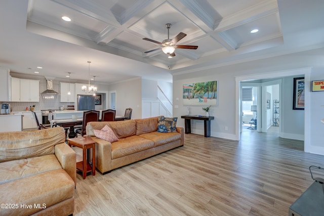 living area with ornamental molding, light wood finished floors, beamed ceiling, and coffered ceiling