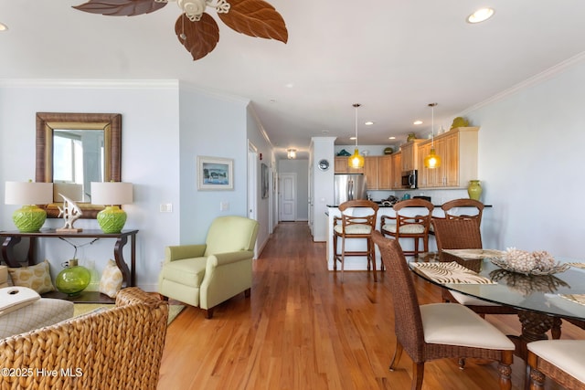 dining area featuring ornamental molding, recessed lighting, light wood finished floors, and a ceiling fan