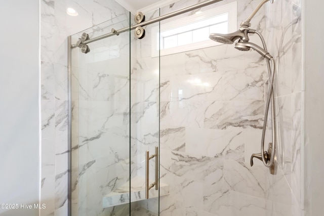 bathroom featuring a marble finish shower