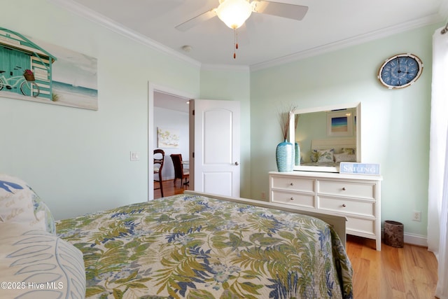 bedroom with ornamental molding, a ceiling fan, baseboards, and wood finished floors