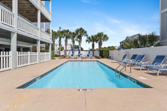 pool featuring a patio area and fence