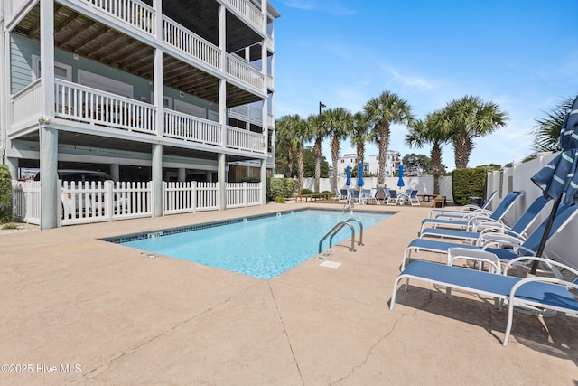 pool featuring a patio area and fence