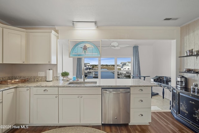 kitchen featuring light stone counters, dark wood finished floors, visible vents, dishwasher, and a peninsula