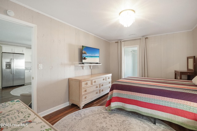 bedroom featuring ornamental molding, dark wood finished floors, stainless steel refrigerator with ice dispenser, and baseboards