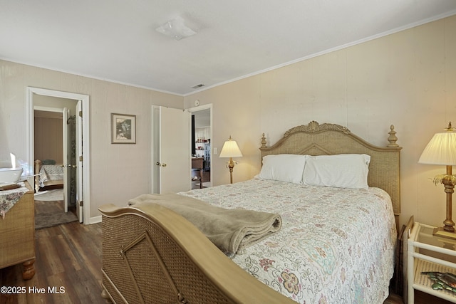 bedroom with wood finished floors, visible vents, and crown molding