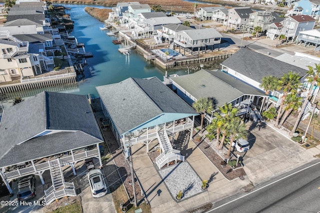 birds eye view of property with a residential view and a water view