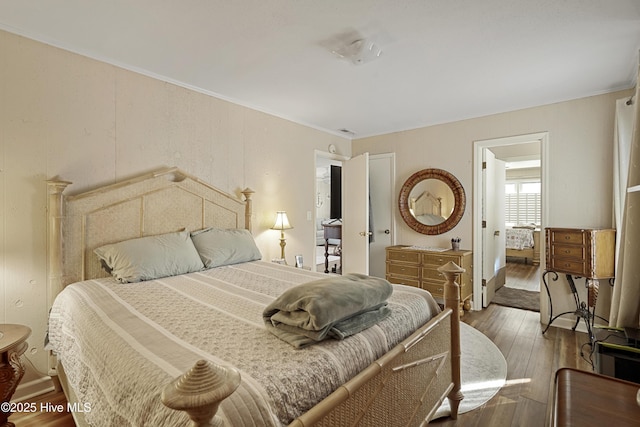 bedroom featuring ornamental molding and wood-type flooring