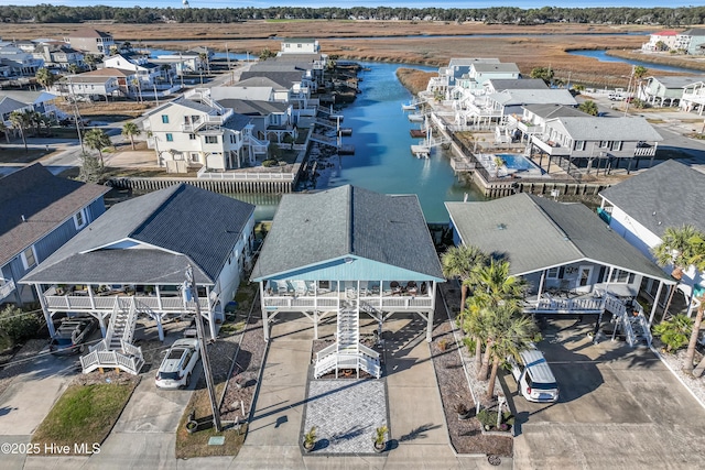 birds eye view of property with a water view and a residential view