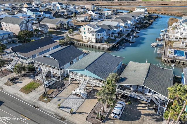 drone / aerial view featuring a residential view and a water view