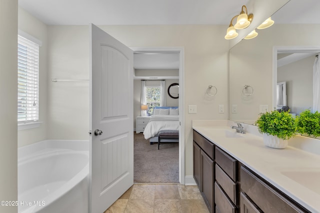 bathroom featuring double vanity, plenty of natural light, ensuite bathroom, and a sink