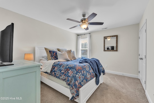 bedroom featuring visible vents, light colored carpet, a ceiling fan, and baseboards