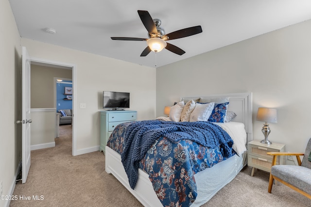 carpeted bedroom with baseboards and ceiling fan