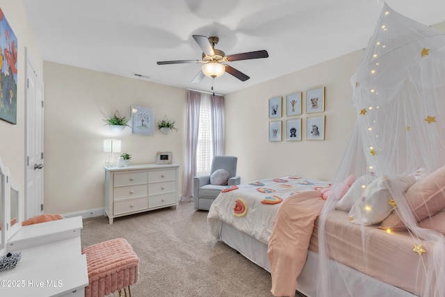 carpeted bedroom with a ceiling fan, visible vents, and baseboards