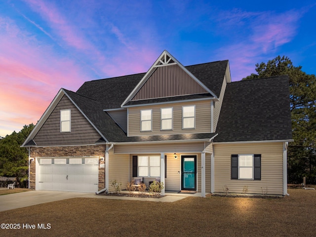 view of front of home featuring a garage, driveway, roof with shingles, and stone siding