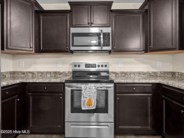 kitchen featuring appliances with stainless steel finishes, light countertops, and dark brown cabinetry