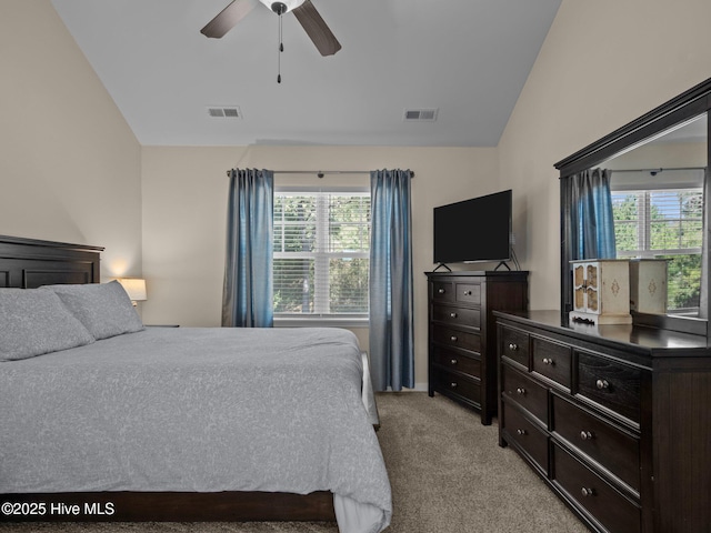 bedroom featuring light colored carpet, visible vents, vaulted ceiling, and multiple windows